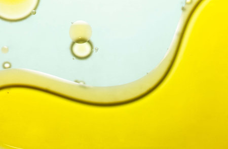 Bubbles in water on a yellow background. Macro photography.の写真素材