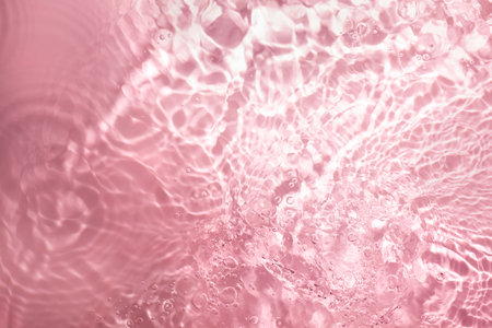 Pink abstract background with ripples and waves in water. Water textureの写真素材