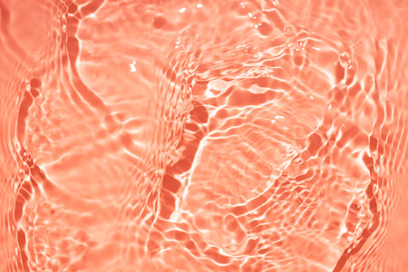 Water ripples on orange background. Abstract texture of water surface.の写真素材