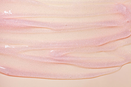 close up of pink cosmetic texture on beige background, makeup and skincare conceptの写真素材