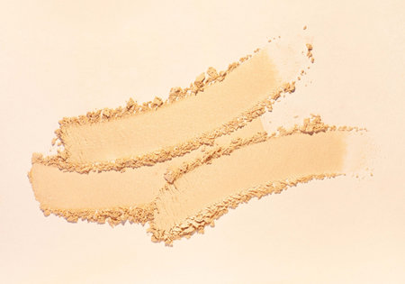 Cosmetic soft eye primer smeared eye shadow swatch isolated on beige background