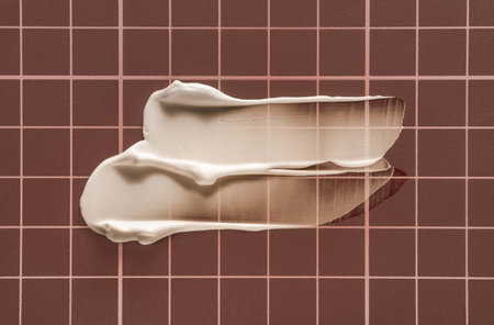 White cosmetic cream on a checkered background. Toned.の写真素材