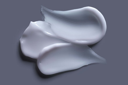 White cosmetic creams on a gray background. Close-up.の写真素材