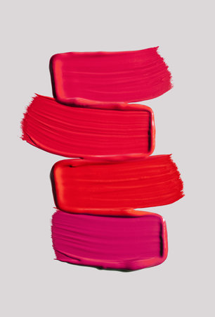 Lipstick satin finish red pink burgundy on a gray isolated backgroundの写真素材