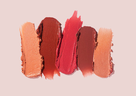 Lipstick satin finish red pink burgundy beige on a gray isolated backgroundの写真素材