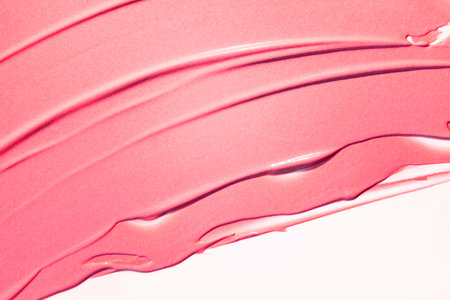 Pink lipstick on a white background close-up. Lipstick smudge.の写真素材