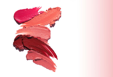 Lipstick abstract strokes smudges background texture multi colored red pink fuchsia isolated on gradient backgroundの写真素材