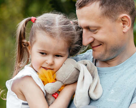 Dads holding his little daughter. Happy family