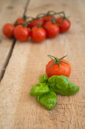 cherry tomatoes on wooden tableの写真素材