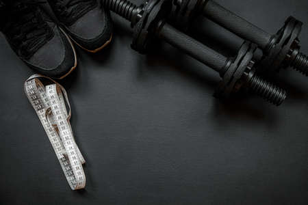 Gym equipment on black background, flat lay. Space for text
