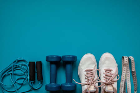 Gym equipment on blue background, flat lay. Space for text