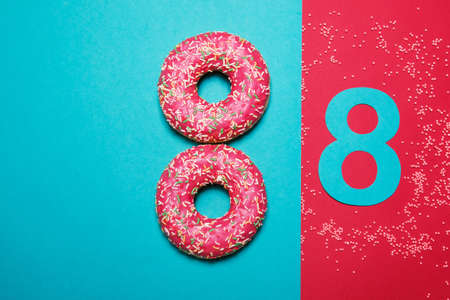 International Women's Day. Postcard for March 8. Flat lay. Donuts in the form of number 8.の写真素材