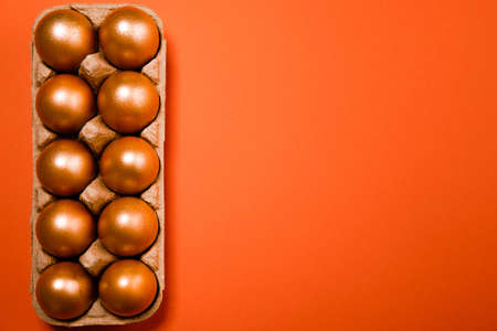 golden easter eggs on a green backgroundの写真素材