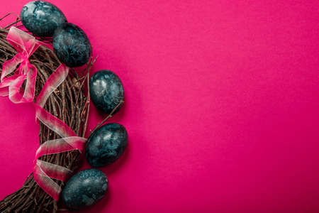 Easter eggs on a crimson background. Place for text.