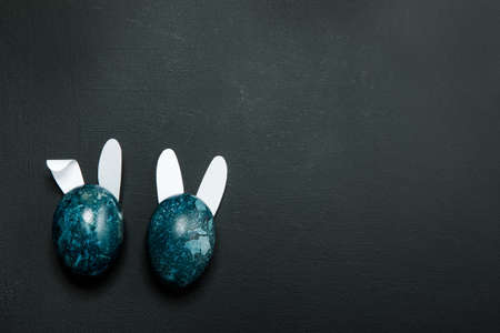 Easter eggs on a black background. Place for textの写真素材