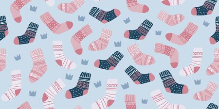 Autumn vector seamless pattern with cute pink socks on light blue background with crowns. Funny doodle socks. Cute winter and autumn holidays hygge textile design in scandinavian styleのイラスト素材
