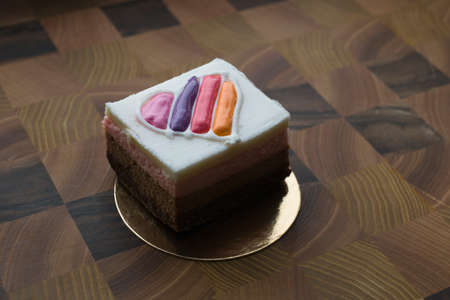 Cake, dessert with colored heart-shaped decoration. On a wooden table. Photo is suitable for...