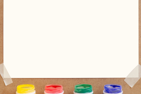 Blank sheet of paper with colorful paint bottles for text or image.の写真素材