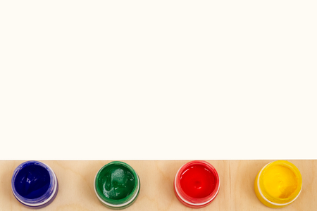 Blank sheet of paper with colorful paint bottles for text or image.の写真素材