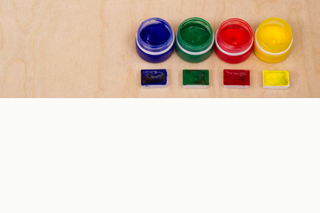Blank sheet of paper with colorful paint bottles for text or image.の写真素材