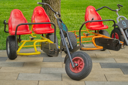 Small pink tricycles for children standing in the park.の写真素材