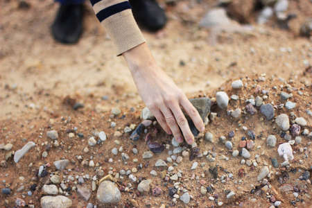 closeup of womans hands holding a stonesの写真素材