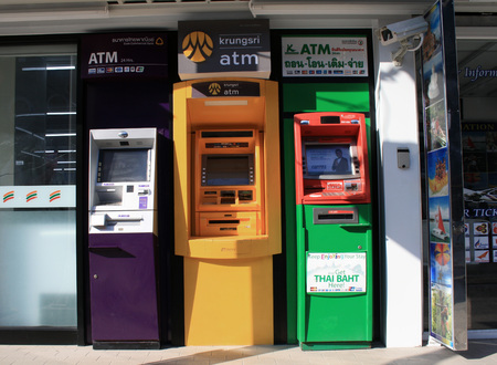 Phuket, Patong beach, Thailand. Colored ATMs on the street of Patong.のeditorial素材