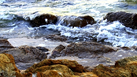 Beach with beautiful rocks. Waves in the morning.の写真素材