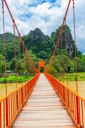 orange bridge over the river at Vang Viengの写真素材