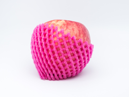 red apple with fruit protection foam on white backgroundの写真素材