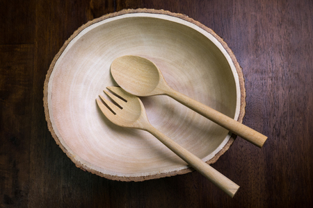 wood bowl set with fork and spoon on wood tableの写真素材