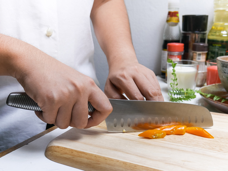 Sliced Orange chili set on tableの写真素材