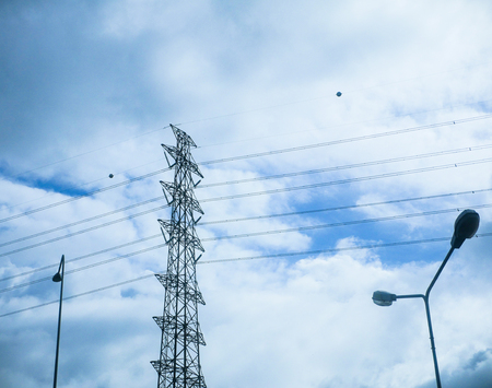 Pylon and  high voltage transmission power line in cloudy sky.の写真素材