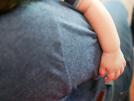 new born baby hand in the hug of motherの写真素材
