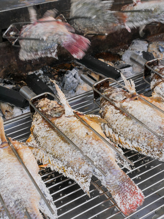 grilled Cichlidae fish with salt, Thai traditional street foodの写真素材