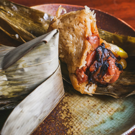 'Zongzi' or 'bakcang', 'bacang' a Chinese traditional food made of glutinous rice  with different fillings and wrapped in bamboo or large leaves.の写真素材