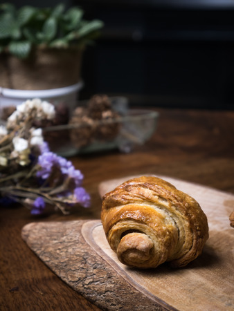 Fresh croissant a flaky, viennoiserie pastry on wooden board.の写真素材