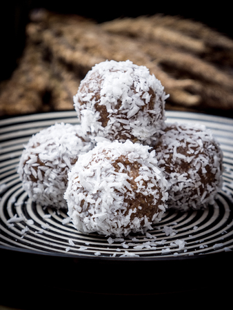 Healthy organic date energy balls with coconut flakes, dried fruits and nuts.の写真素材