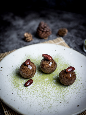 Healthy date energy balls with green tea, red bean, dried fruits and nuts.の写真素材