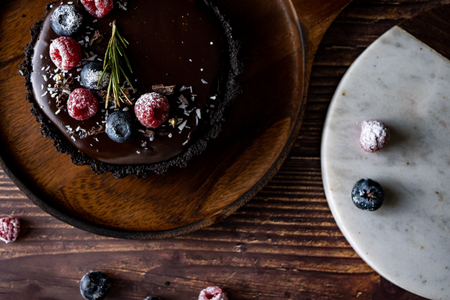 Tart Chocolate cheesecake with fresh berries. delicious dessert for Birthday. Set on wooden table background.の写真素材