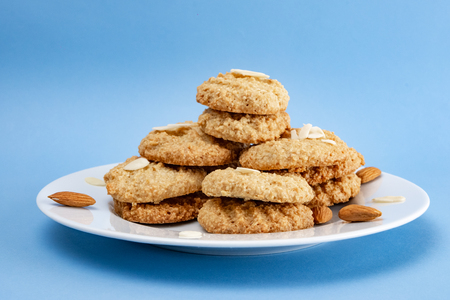 Gluten-Free Cookies almond with almond slice in white plate set on light blue background.の写真素材