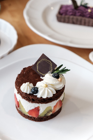 Delicious Chocolate cake with whip cream and fruit.の写真素材
