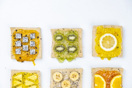 Delicious colourful minimal mix fruits jam on sliced bread.