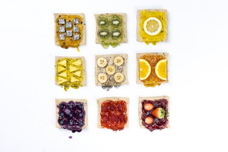 Delicious colourful minimal mix fruits jam on sliced bread.の写真素材