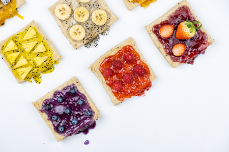 Delicious colourful minimal mix fruits jam on sliced bread.の写真素材