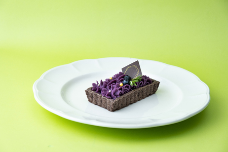 delicious Purple Sweet Potato Tart. Set on green background.の写真素材