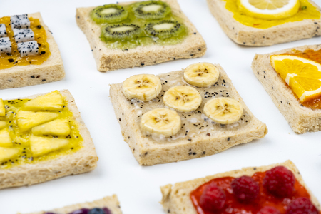 Delicious colourful minimal mix fruits jam on sliced bread.の写真素材