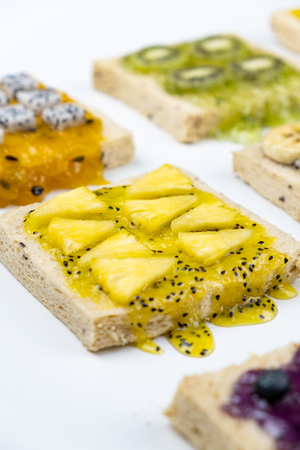 Delicious colourful minimal mix fruits jam on sliced bread.の写真素材