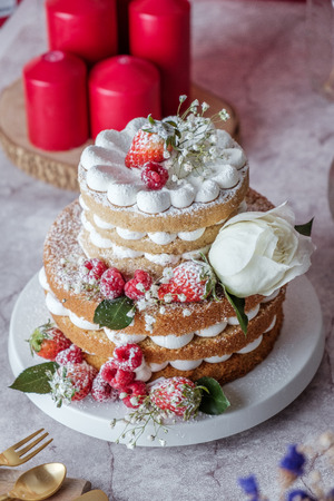 White cake Decorated with flower and berries. For celebrate party.の写真素材