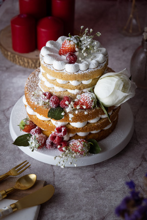 White cake Decorated with flower and berries. For celebrate party.の写真素材